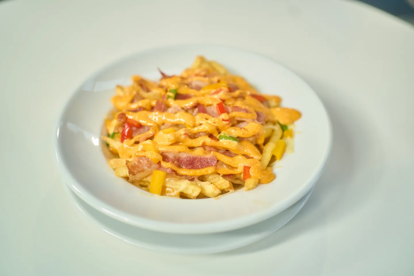 Loaded fries photographed with the optional peppers upgrade