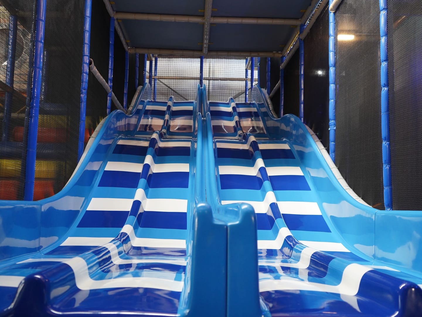 Blue racing slides descending from the Main Play structure.