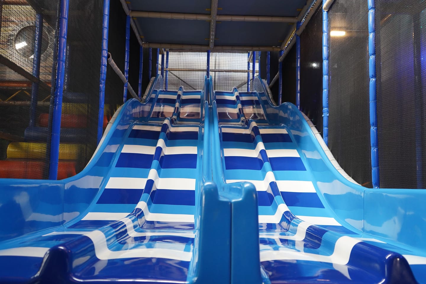 Blue racing slides descending from the Main Play structure.