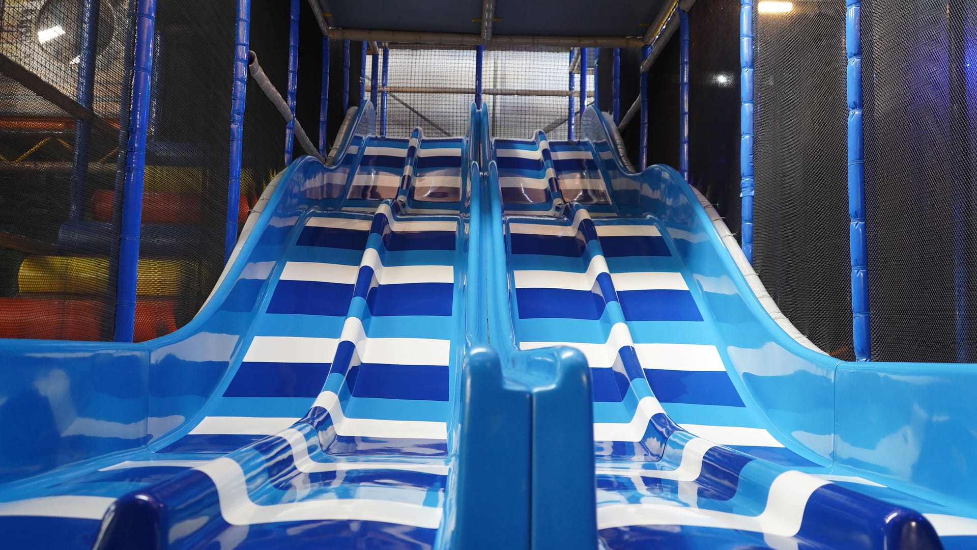 Blue racing slides descending from the Main Play structure.