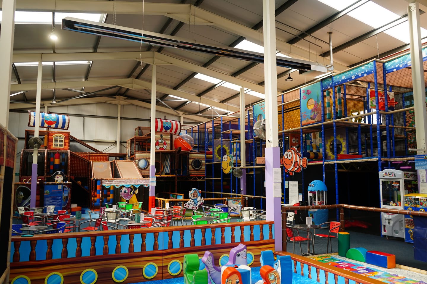 Wide elevated view across Main Play, the sports court and family seating.
