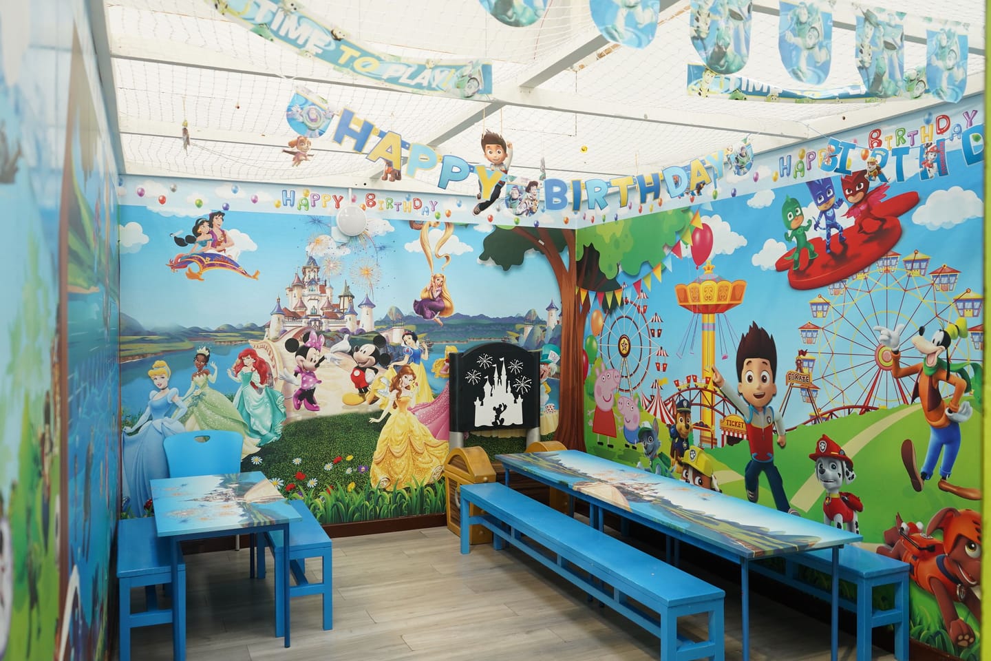 Blue themed private party room with tables prepared and no guests present.