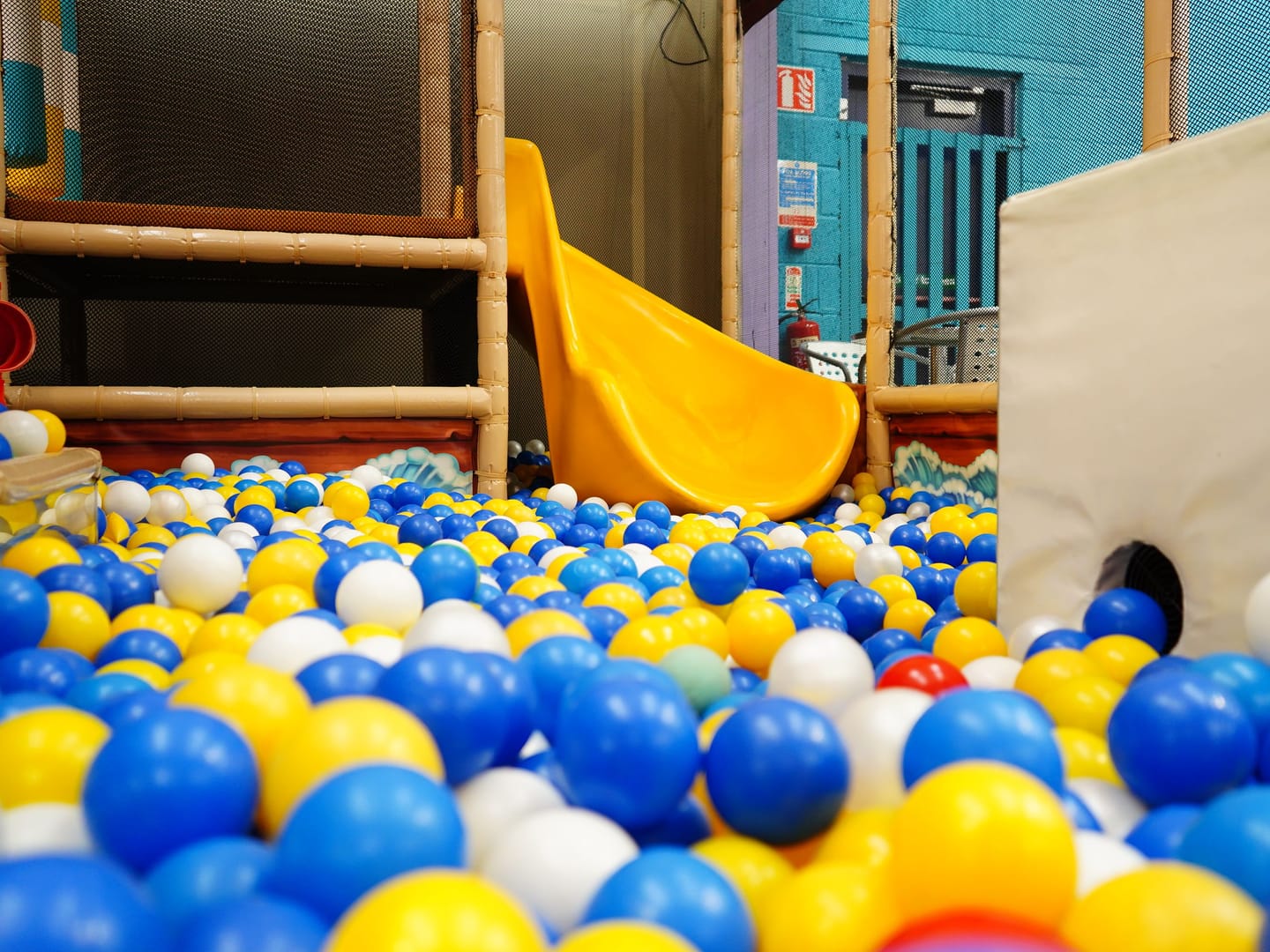 Wide view of the Toddler Area ball pit and small slide.