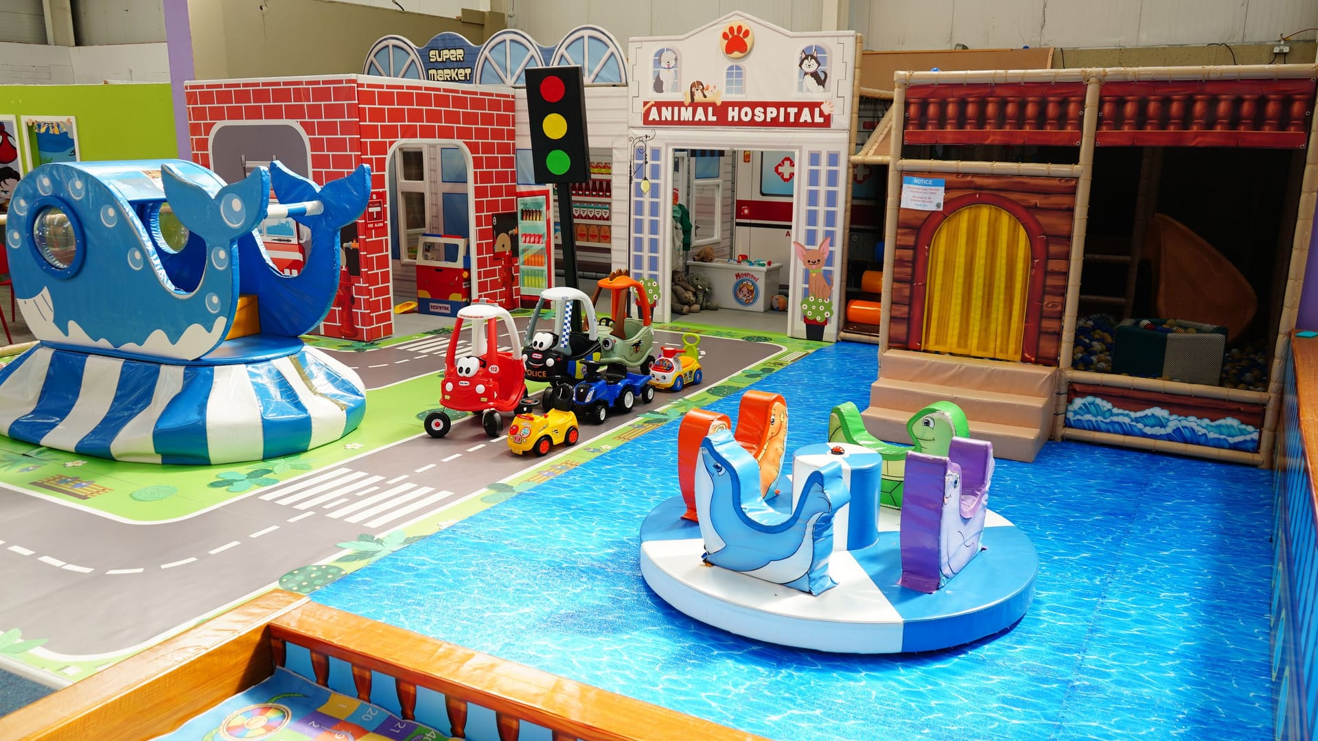 Wide view of the separate Toddler Area with low play features and role-play façades.